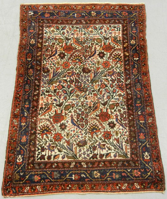 Hand tied Persian rug, Made in Iran cloth label, red bo: Hand tied Persian rug, Made in Iran cloth label, red border, white ground with polychrome floral, bird and foliate design, 4'11" x 3'3"