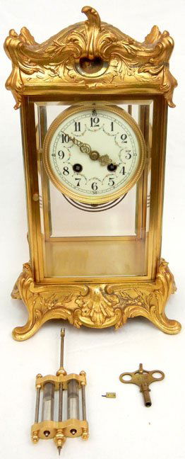 Crystal regulator clock, gilt metal foliate case, bevel: Crystal regulator clock, gilt metal foliate case, beveled glass, hand painted porcelain face, impressed 2204,4" on back, mercury pendulum, with clock key, key marked E.N.Welch MF'G Co.