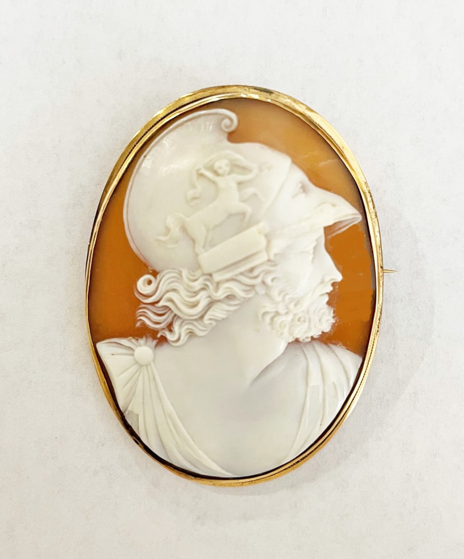 Victorian 14k gold Cameo Brooch: Victorian 14k gold cameo brooch, hand carved shell cameo depicting Greco-Roman soldier, pin measures 2 3/8" long x 1 3/4' wide, 14k gold mounting, hinged bale for chain, stamped K14, weight 12.9 grams