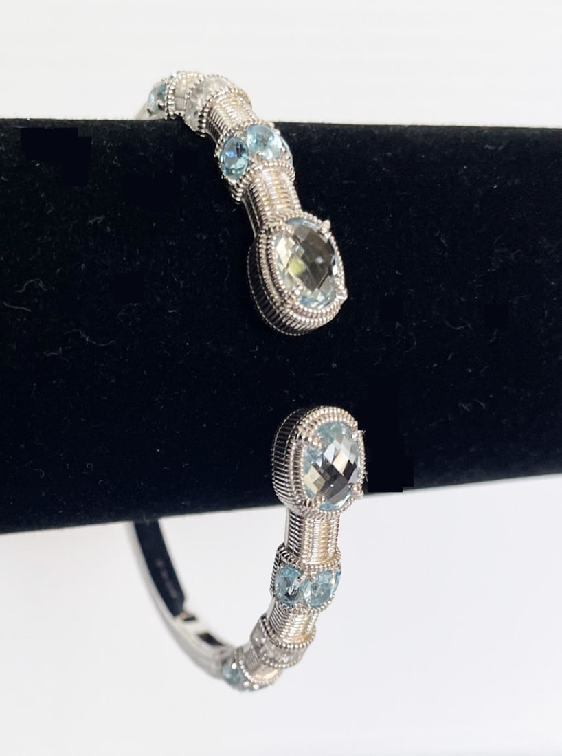 Judith Ripka Sterling Silver Blue Topaz Bracelet: Judith Ripka sterling silver blue topaz bracelet, hinged bangle bracelet, 6.25" inside circumference, stamped Ripka 925, weight 21.5 grams