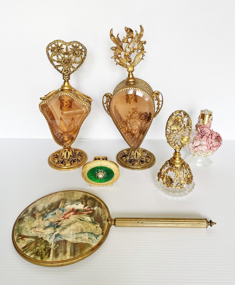 Six Vintage Dresser Pieces: Six vintage dresser pieces, two tall ornate brass filigree perfume holders, one 10" high, amber glass and heart shaped finial, glass perfume bottle is broken inside, one 11" high with floral finial, g