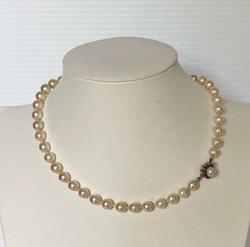 Cultured Pearl Necklace with 14K Gold Jeweled Clasp: Cultured pearl necklace with 14k gold jeweled clasp, 7mm pearls, pale ivory color, 15.5" long, 14k white gold clasp set with pearl and small rubies or garnets, stamped 14k