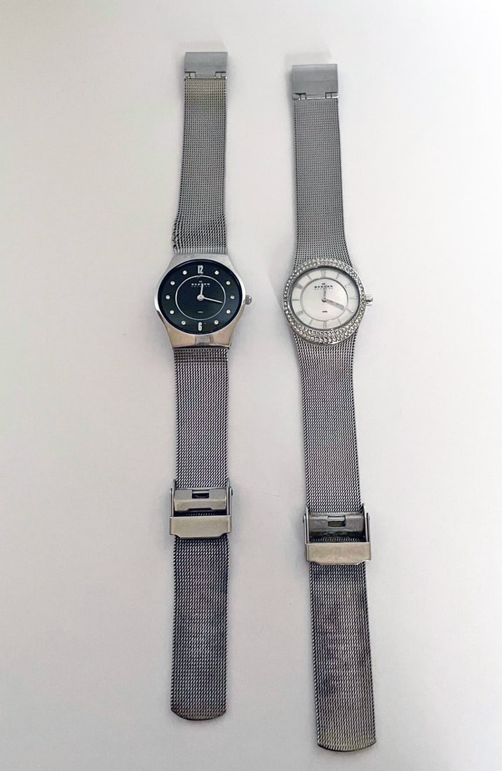 Two Lady's Skagen Wristwatches: Two lady's Skagen wristwatches, quartz movement watches with adjustable mesh bands, 8 3/4" long, one with black dial, 28mm case, mineral crystal, and one with jeweled bezel and mother of pearl dial, 2
