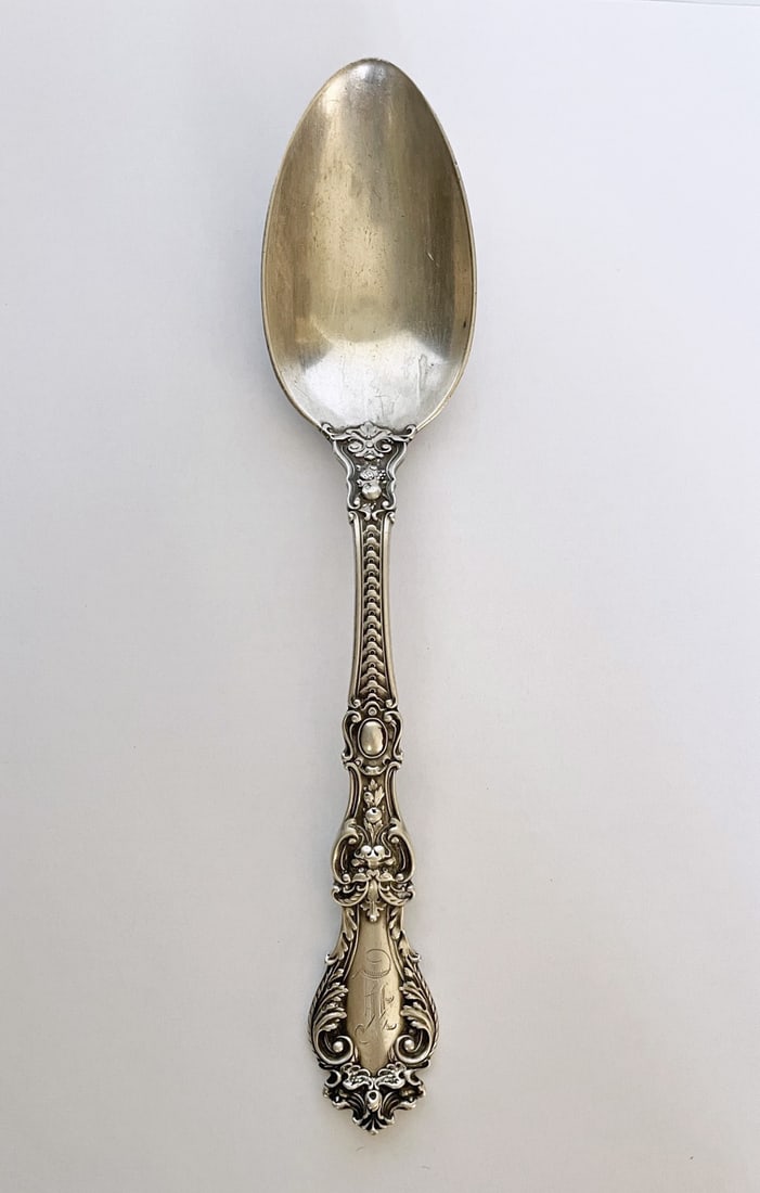 Ornate Sterling Silver Serving Spoon: Ornate sterling silver serving spoon, monogrammed initial, 8.75" long, stamped Sterling Patent 1900, British hallmarks, unidentified, weight 3.05 ozt.