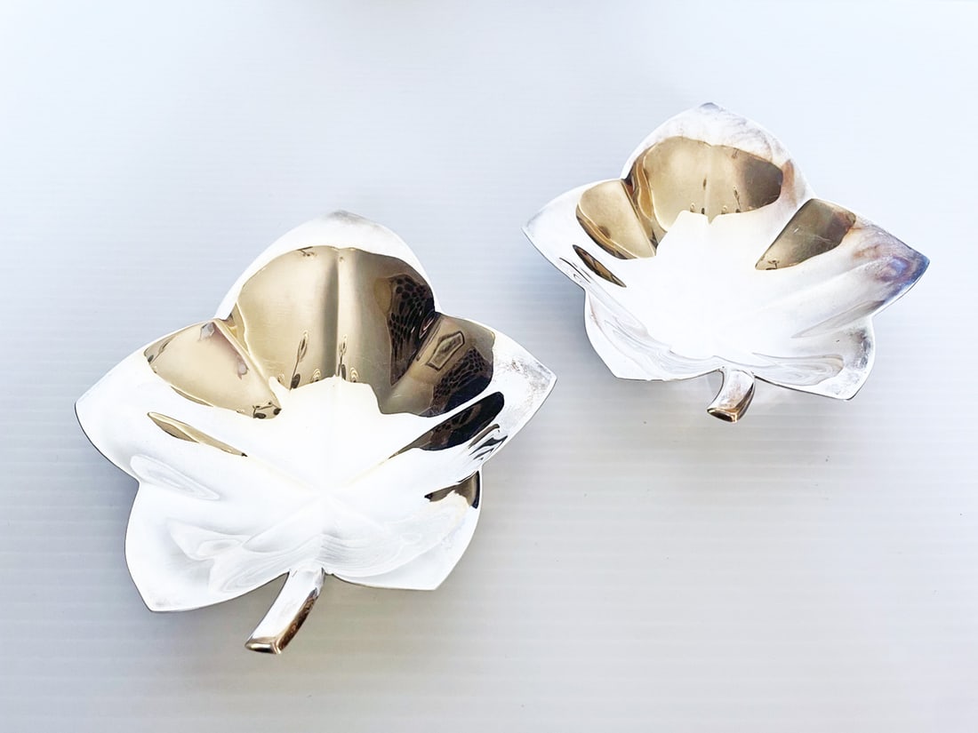 Pair of Tiffany & Co. Sterling Silver Leaf Shaped Dishes: Pair of Tiffany & Co. sterling silver leaf shaped dishes, two nut or candy dishes measuring 5.75" long x 5.25" wide x .75" deep, high polished finish and two ball feet, stamped Tiffany & Co. Makers St