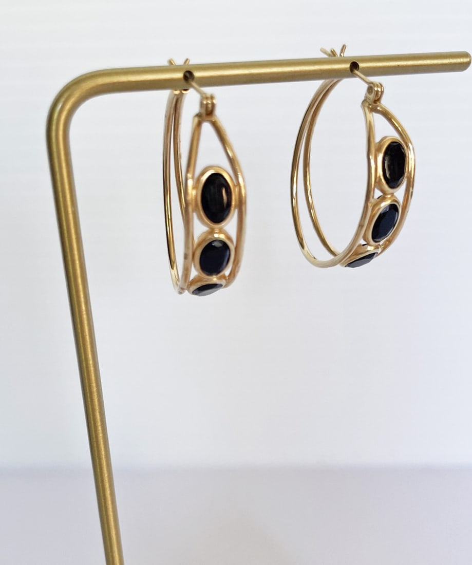 14k Gold Black Onyx Oval Hoop Earrings: 14k gold black onyx oval hoop earrings, pierced post earrings measure 1 1/8" long, and are 1/4" wide, each set with three oval faceted black onyx, stamped 14k, weight 3.5 grams