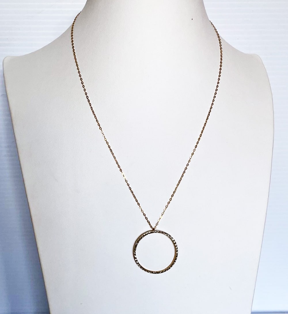 14k Gold Circle Pendant and Chain: 14k gold circle pendant and chain, yellow gold topped with white gold, textured design and two small clear stones, pendant is 1 1/8" in diameter, 17.5" fine link chain, stamped 14k S.L.C, weight 1.4 g