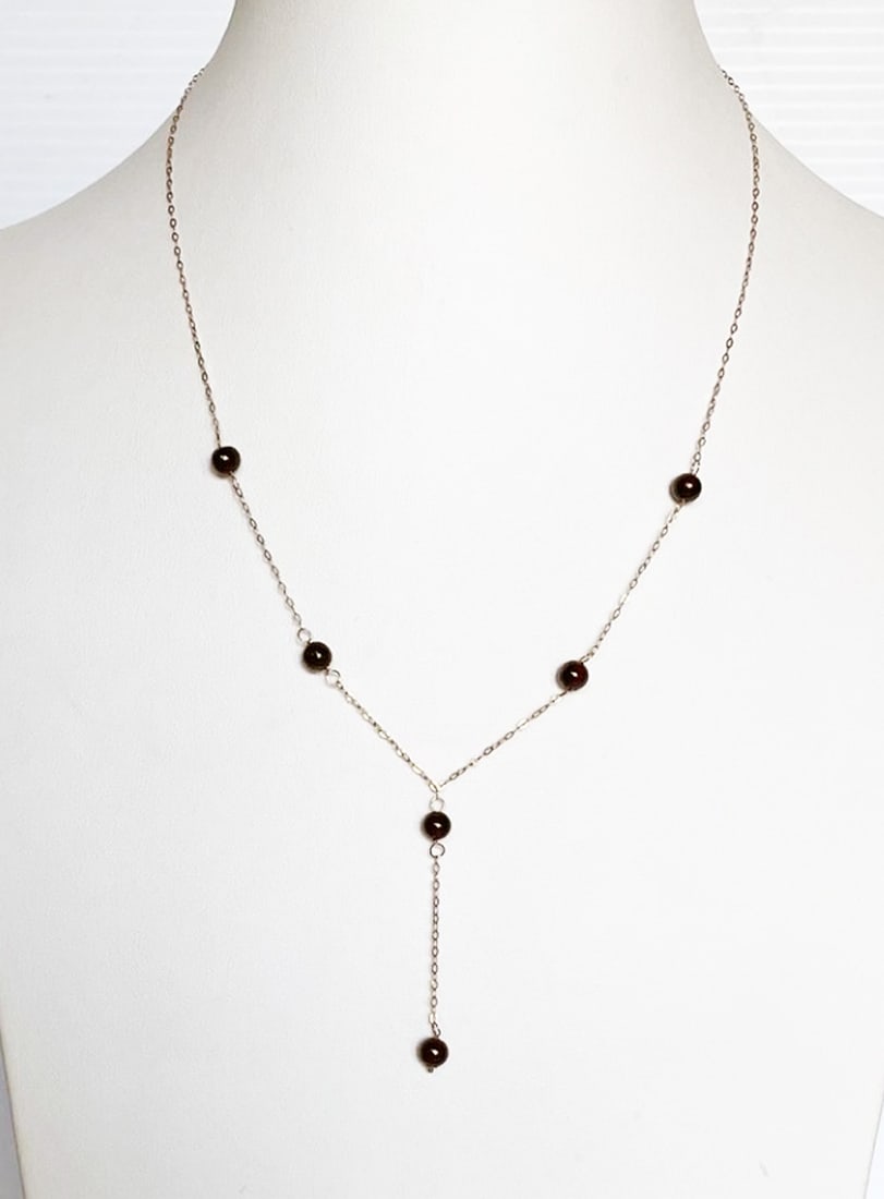 14k Gold Garnet Bead Y Necklace: 14k gold garnet bead Y necklace, 16.5" long with 1.75" drop, 6-5mm garnet beads, stamped 14k, weight 2.0 grams