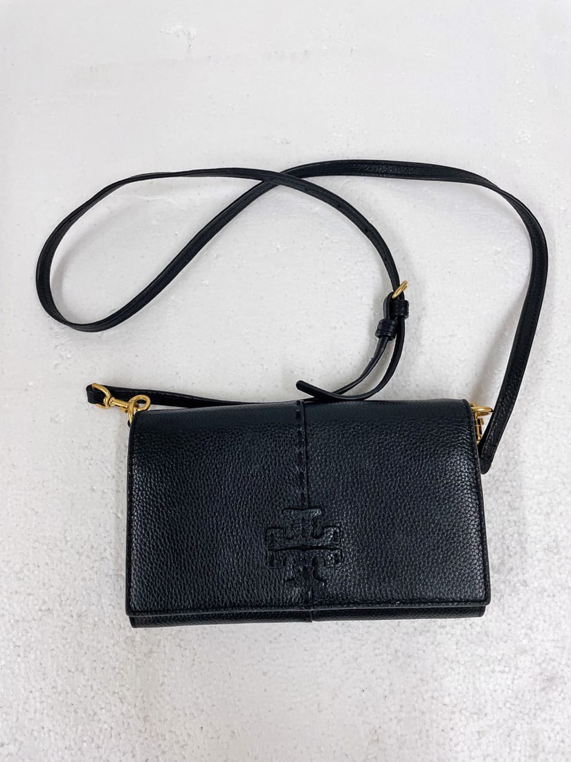 Tory Burch Leather Crossbody Bag: Tory Burch leather crossbody bag, snap closure, monogram on front, adjustable leather shoulder strap, bag measures 5" high (not including strap) x 8" x 1 1/4"