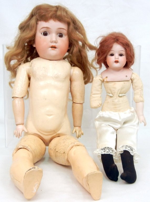 Two bisque head dolls, P. Sch. bisque shoulder head and: Two bisque head dolls, P. Sch. bisque shoulder head and cloth body, porcelain arms, brown glass eyes, painted lashes, open mouth with teeth, marked on back of head "P.Sch. Germany 4/0 G", wearing dres