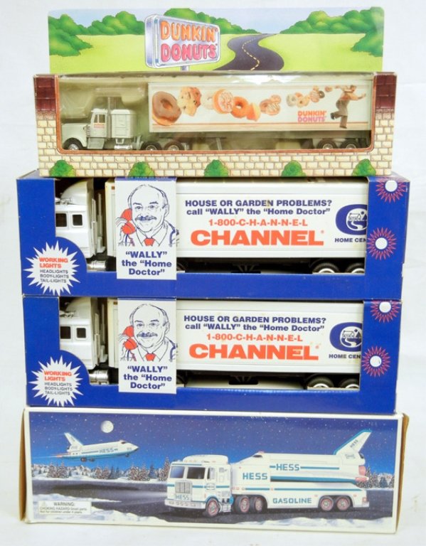 Four new in box collectible trucks, including two: Four new in box collectible trucks, including two Channel toy trunk banks, Channel is no longer in business, Hess 1999 toy truck and Space Shuttle with Satellite, and a Dunkin Donuts Tractor and Trail