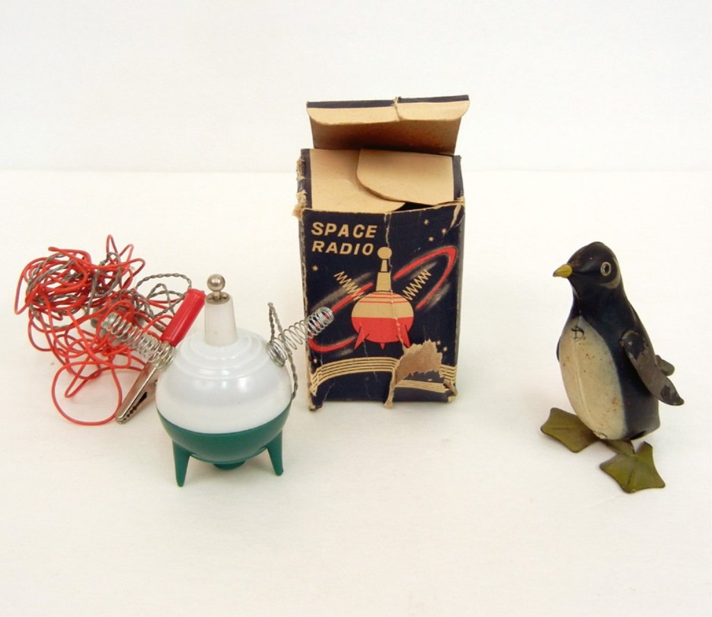 Early tin litho wind up penguin, 3 1/2", still winds,: Early tin litho wind up penguin, 3 1/2", still winds, unmarked, and a Nasco Space Radio in original box