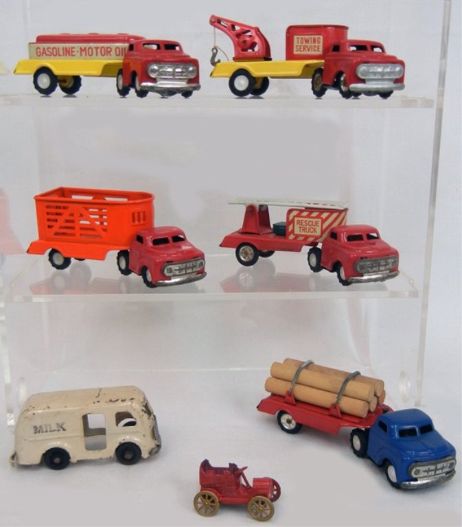 Five Japan tin litho trucks, all with license plate: Five Japan tin litho trucks, all with license plate that reads "S-2023", including Rescue truck, Towing service, Animal trailer, Gasoline Motor Oils, and a log truck, with a tin litho milk truck marke