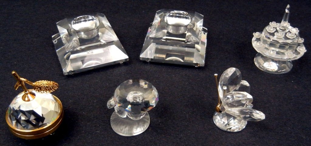 Grouping of six Swarovski crystals, including a pair of: Grouping of six Swarovski crystals, including a pair of candle holders, birthday cake, apple picture holder, butterfly, and mushrooms, all marked, tallest measures 2" high