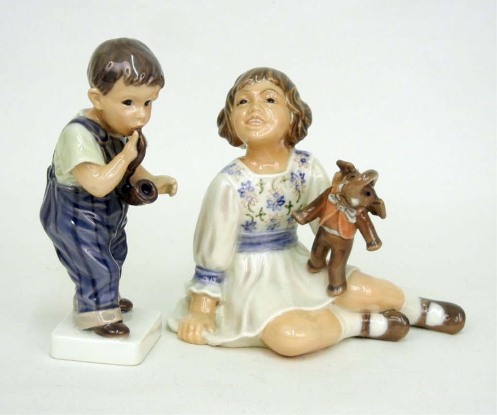 Two Dahl Jensen porcelain figurines, #1027 D boy smokin: Two Dahl Jensen porcelain figurines, #1027 D boy smoking pipe, 6 1/2"; and #1204 girl holding toy elephant, 6" high