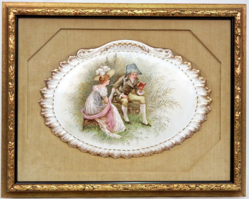 Hand painted porcelain charger in velvet lined gilt woo: Hand painted porcelain charger in velvet lined gilt wood frame, young couple seated in grasses, man reading book, signed Ina lower right, porcelain measures 9 1/2" x 13 3/4", frame 15 3/4" x 20"