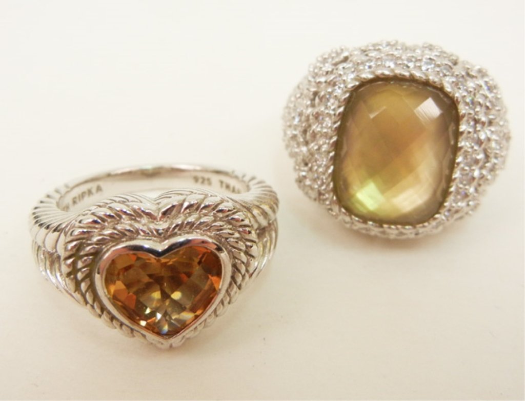 Two Judith Ripka sterling silver rings, one with amber : Two Judith Ripka sterling silver rings, one with amber colored heart shaped center stone, 5/8" wide at center, and one with yellow faceted rectangular center stone with pave C.Z.'s in mounting, 3/4" w
