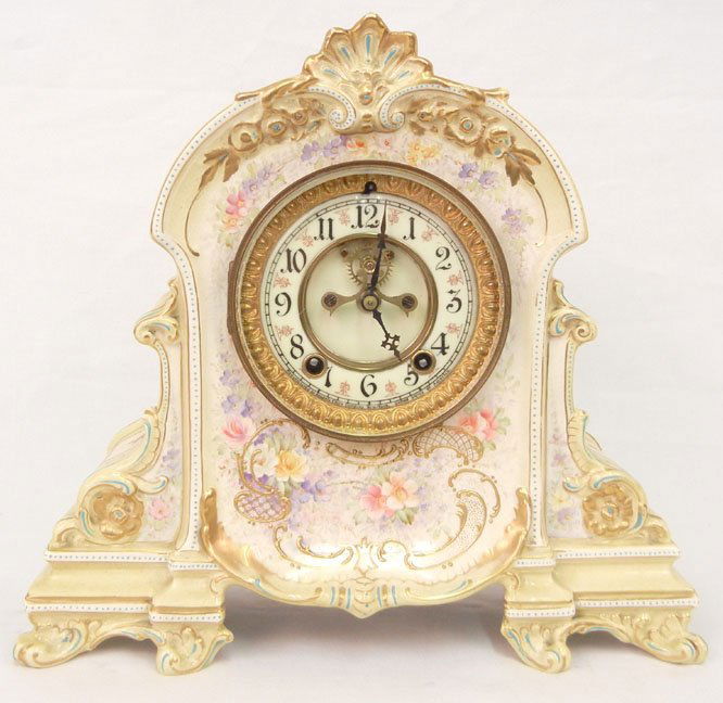 Royal Bonn cased Ansonia clock, porcelain case with flo: Royal Bonn cased Ansonia clock, porcelain case with floral and gilt decoration, marked on back and face, open escapement, 12" x 13" x 5", working