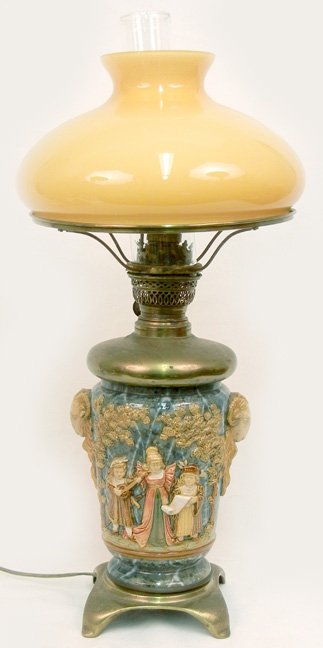 Electrified oil lamp, English pottery, figures in lands: Electrified oil lamp, English pottery, figures in landscape, ram's head handles, possibly Doulton Burslem, brass bottom, case glass shade, 24"