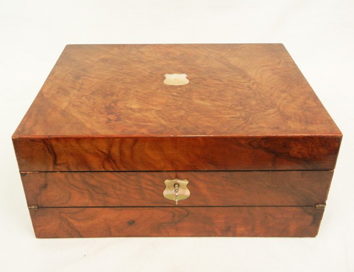 Walnut lap desk, with inlaid mother of pearl medallion: Walnut lap desk, with inlaid mother of pearl medallion on lid, inlay on front hinged fold out lid, and escutcheon, hinged letter folio inside lid with tooled leather and silk lining, interior compartm