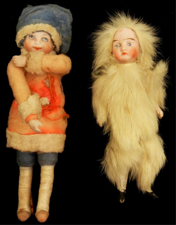 Two hard to find German Christmas dolls: Two hard to find German Christmas dolls, including 6 1/2" bisque head and hands, cotton batting clothes, and a 5" bisque head, arms, and legs, fur clothes, used on Christmas trees, ca.1910