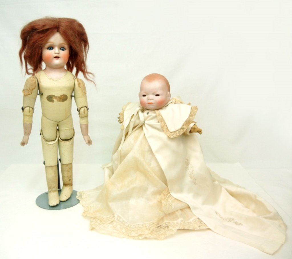 Grace S. Putnam Bye-Lo baby: Grace S. Putnam Bye-Lo baby, painted features, celluloid hands, cloth body, wearing antique dress, slip, underwear, socks, overcoat with matching bonnet, marked on head "Copr. By Grace S. Putnam, Made