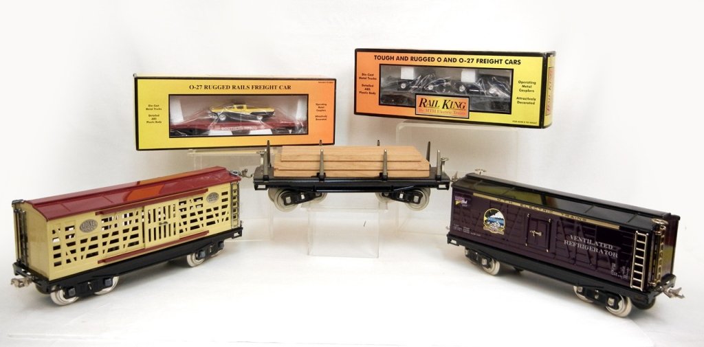 Grouping of Rail King 0, 027 and G scale freight cars: Grouping of Rail King 0, 027 and G scale freight cars by MTH, two new in boxes. MTH Auto Transport Flatcar with Ertl '65 Shelby Cobras, Southern Flatcar with '57 Ford Ranchero, and flatcar with wood p