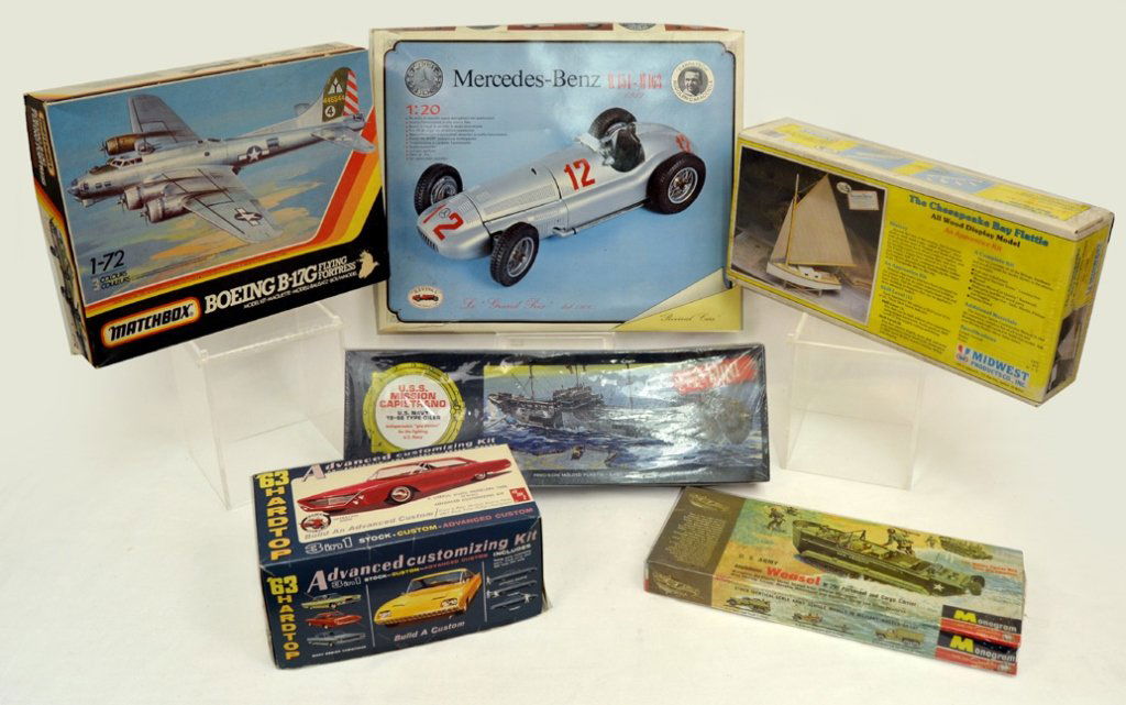 Grouping of scale model kits: Grouping of scale model kits including three still sealed in boxes Monogram U.S. Army Amphibians Weasel, Revell U.S.S. Mission Capistrano, Midwest Products Co. The Chesapeake Bay Fattie, and in boxes