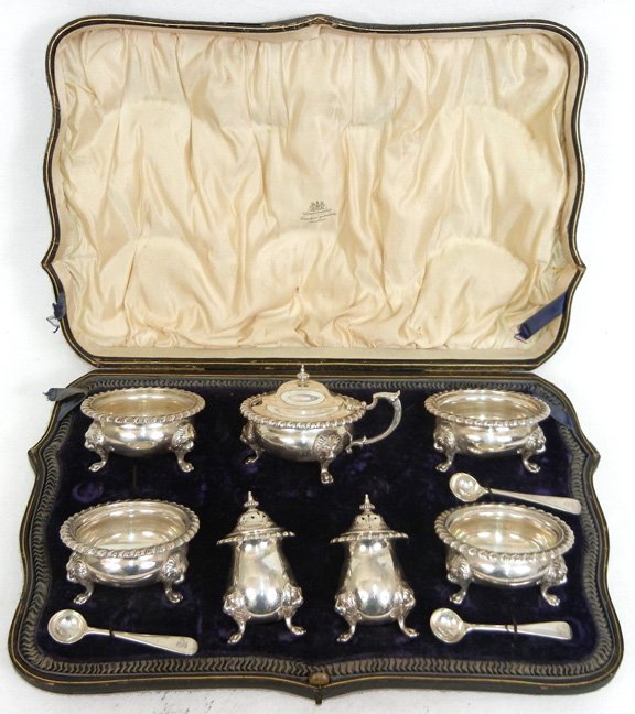 Wakely & Wheeler English sterling condiment set: Wakely & Wheeler English sterling condiment set, London, comprised of four open salts, two pepperettes, and a mustard with hinged lid, three salt spoons, all with raised lion heads at knees, paw feet,