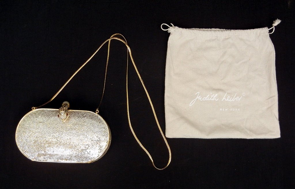 Judith Leiber rhinestone purse with snake clasp: Oval shaped purse 6 3/4" long x 4" high x 1 1/2" deep, entire body covered with mirrored stones, gold tone trim, snake head clasp with faux pearl and red stone eyes, gold leather lining, chain handle