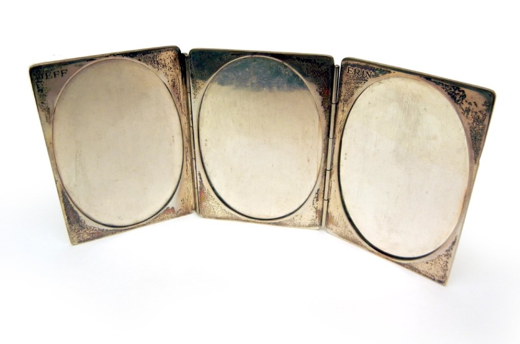 Tiffany & Co. three paneled sterling silver picture: Frame measures 7 1/2" long (open) x 3 3/8" high, openings for images are 3 1/2" long x 2 1/4" wide, one engraved "Jeff", and one engraved "Erin", marked Tiffany & Co., Sterling Silver, weight 4.67 tro