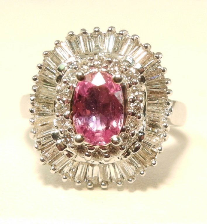 Franklin Mint 18k gold, pink sapphire and diamond ring: One oval 1.0 carat pink sapphire surrounded by 1.0 carat of round and baguette diamonds, 18k white gold mounting, marked 18k, 750, F.M. (Franklin Mint), size 5 1/2, weight 6.6 grams/4.3 dwt, late 20th