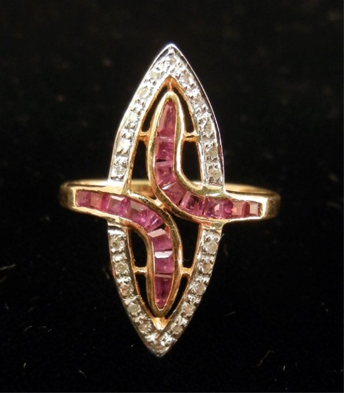 Gold, ruby and diamond ring: Marquise shaped 14k gold mounting with approximately 0.12 carats round diamonds and 0.25 carats calibre cut rubies, front of ring is 1" long, size 7, marked 14k, weight 3.2 grams/2.1 dwt, late 20th C.