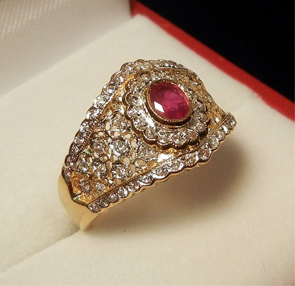 Gold, ruby and diamond ring: 18k gold mounting with center oval ruby measuring 0.35 carats, surrounded by 0.25 carats in diamonds, front of ring is 1/2" wide, size 7, marked 750 (18k), weight 4.8 grams3.1 dwt, late 20th C.