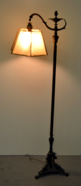 Hubley iron bridge lamp: Hubley iron bridge lamp, 391A, column standard, three dolphin base on three paw feet, marked on bottom, original parchment shade, 54 1/2" high