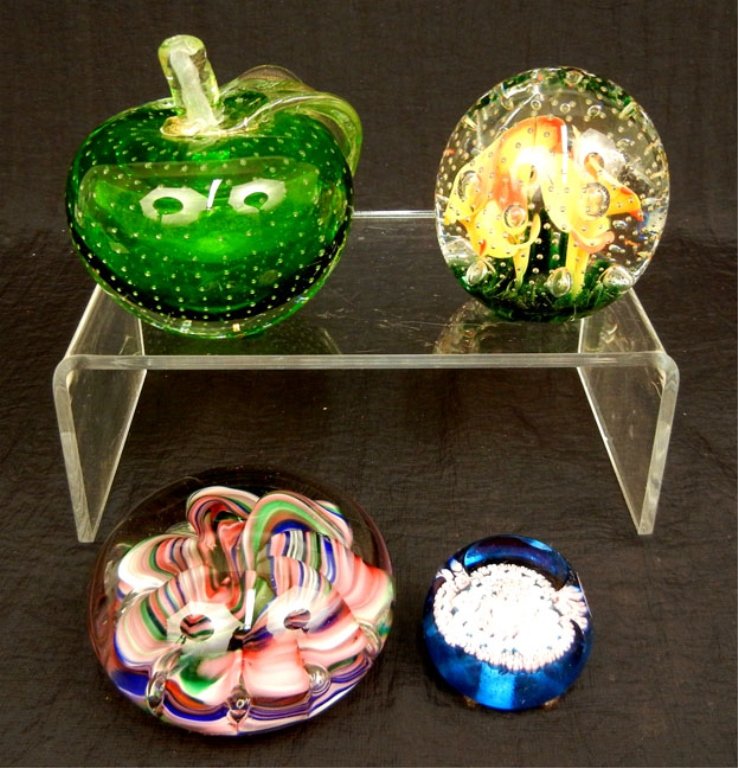 Grouping of four art glass paperweights: Grouping of four art glass paperweights, including two by Joe St. Clair, one with a label on bottom with millefiori design, and a Murano style apple shaped paperweight, tallest 4 1/4" high
