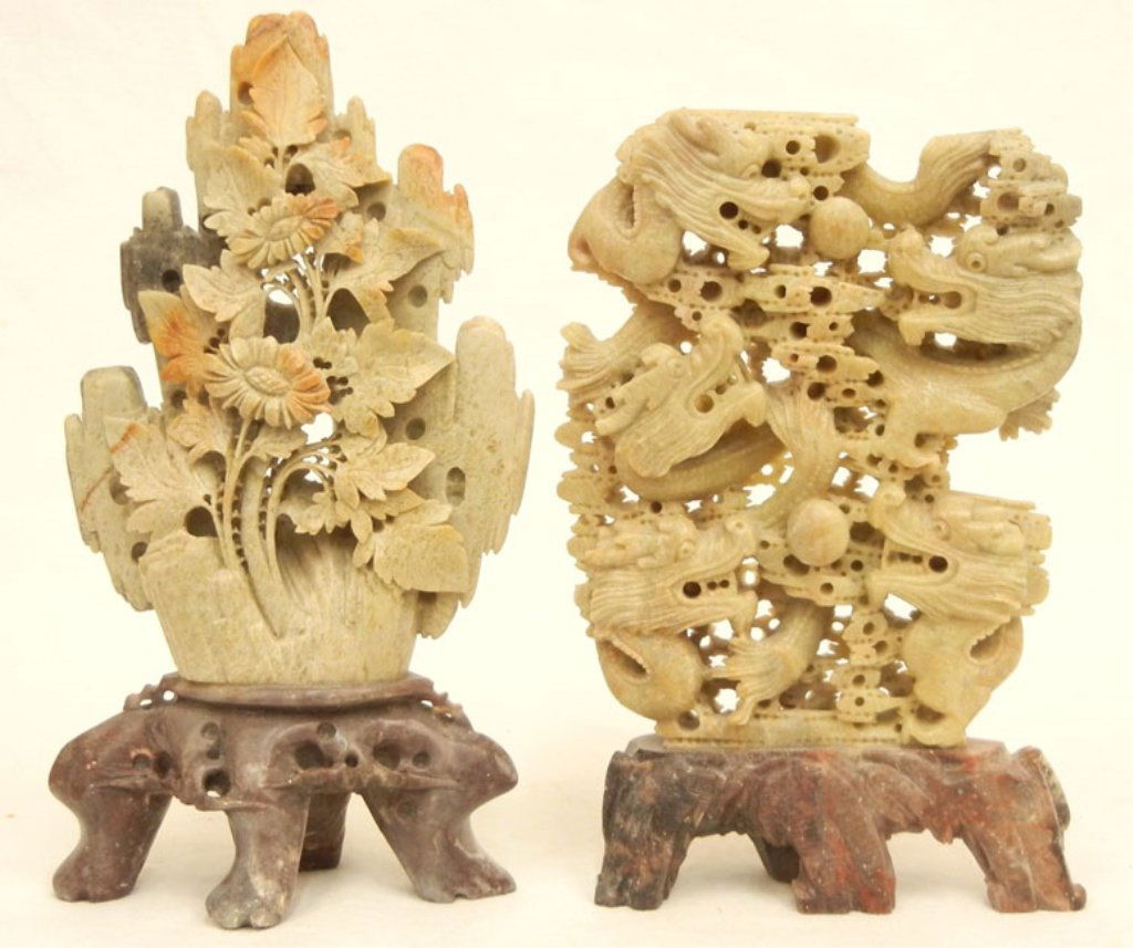 Two soapstone carvings: Two soapstone carvings, including one of five dragons, chasing two pearls, mounted on base, 7 5/8" high, and one of florals, foliates and cactus, mounted on base, 8 7/8" high, carved O/Z on footed bas