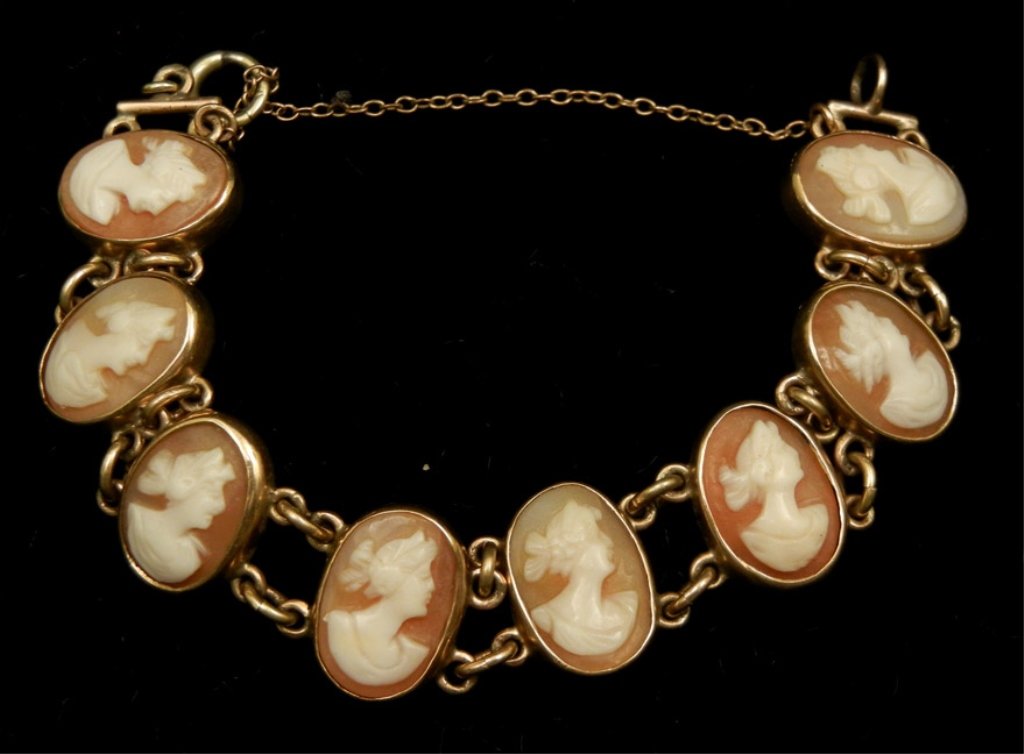 Gold cameo bracelet: Carved shell cameo bracelet, 14k gold mounting, eight oval bezel set cameos, 5 3/4" long x 1/2" wide, safety chain, marked 14k, early 20th C.