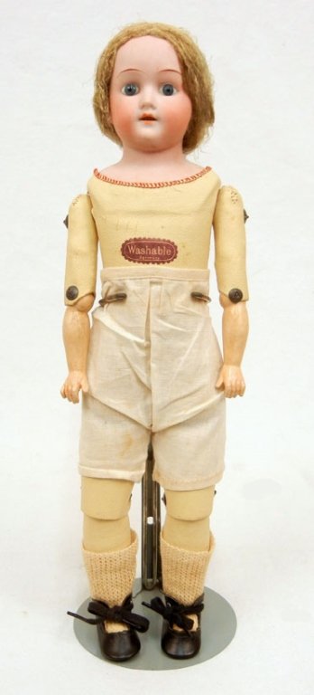 German bisque shoulder head doll: German bisque shoulder head doll, leather jointed kid body, composition lower arms, blue glass eyes, painted lashes, open mouth with upper teeth, wearing pantaloons, socks and shoes, marked "Germany, 