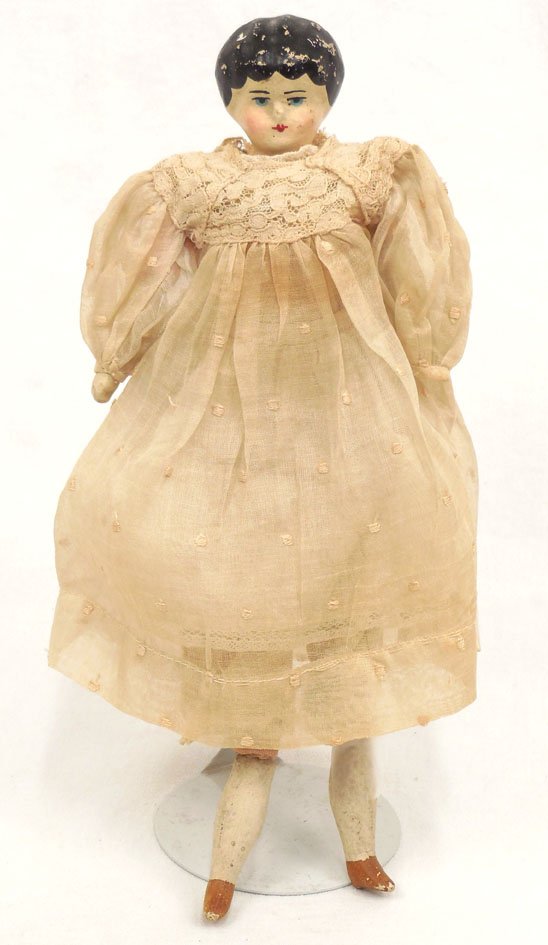 Composition shoulder head doll: Composition shoulder head doll, straw body, wooden arms and legs, unmarked, painted features, painted and molded hair and shoes, wearing dress, slip, and pantaloons, 10" high