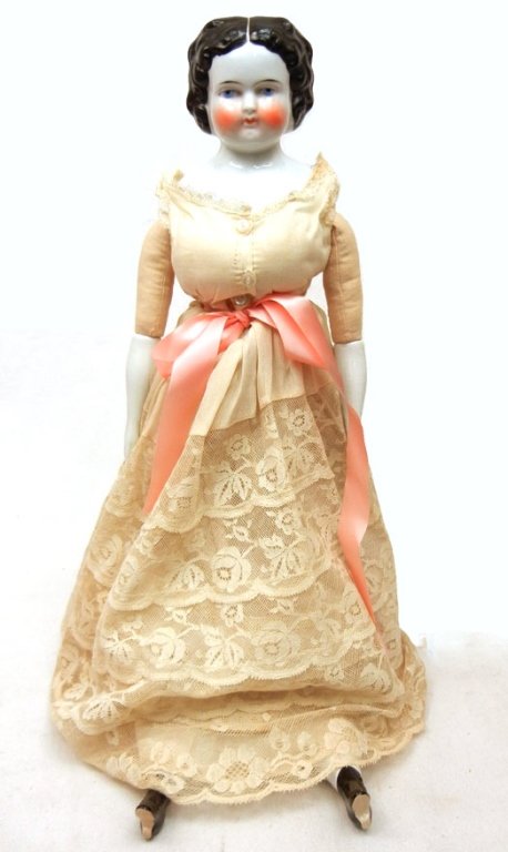Antique china head doll, 20": Antique china head doll, 20", wearing antique dress, molded china head, hair, arms, and legs with boots, impressed on back "5", cloth body