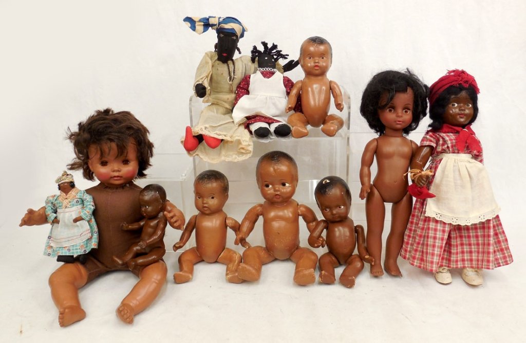 Grouping of eleven black dolls: Grouping of eleven black dolls, including five jointed composition dolls, unmarked, one composition marked "W.O.L" on back, 14 1/2", Uneeda Doll Co. hard plastic, 14", Effanbee cloth and vinyl doll, 1