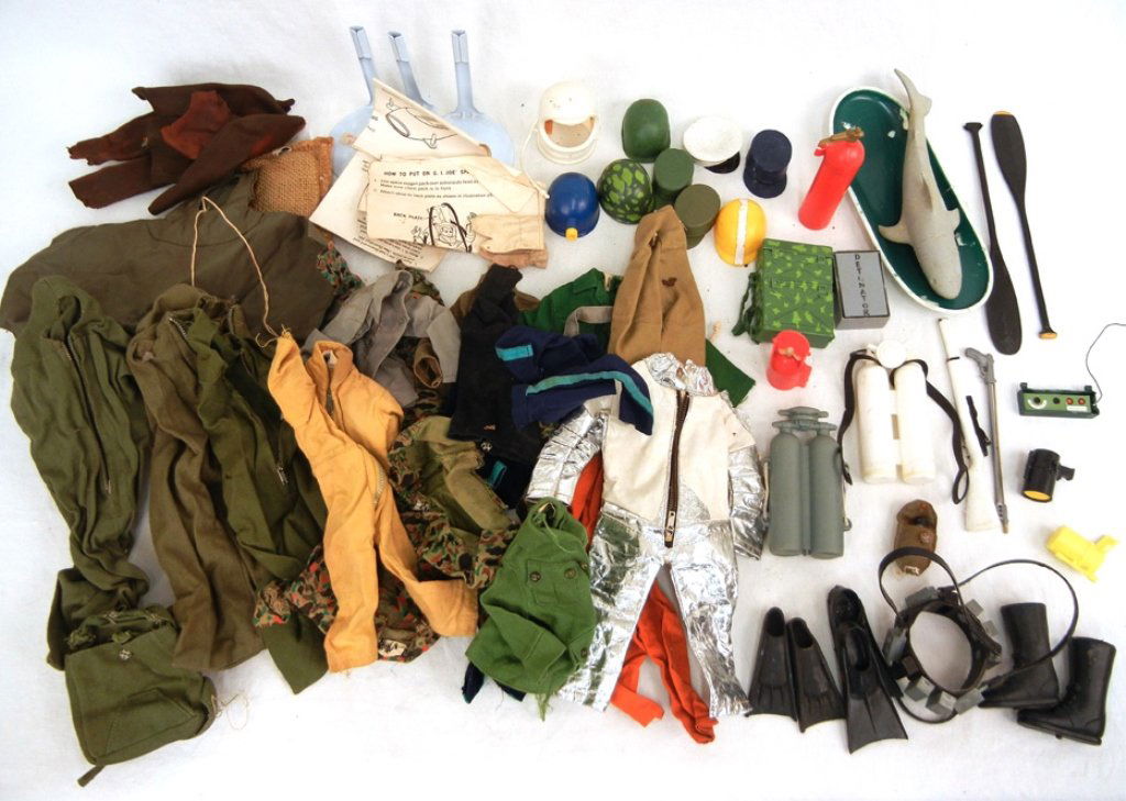 Large grouping of G.I. Joe clothing and accessories: Large grouping of G.I. Joe clothing and accessories, includes paddles, boat, shark, tank, detonator, scuba gear, holsters, guns, spool of wire, boxes, flippers, boots, poncho, sleeping bags, outfits,