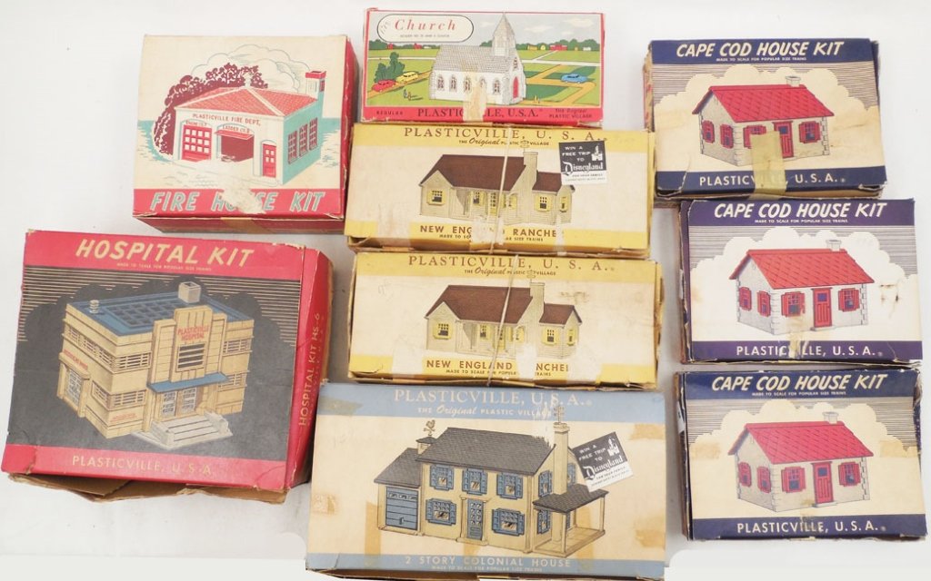 Grouping of nine Plasticville buildings: Grouping of nine Plasticville buildings complete in boxes, including three Cape Cod House Kits, Church, two New England Ranchers, a 2-Story Colonial House, Firehouse Kit, and a Hospital Kit