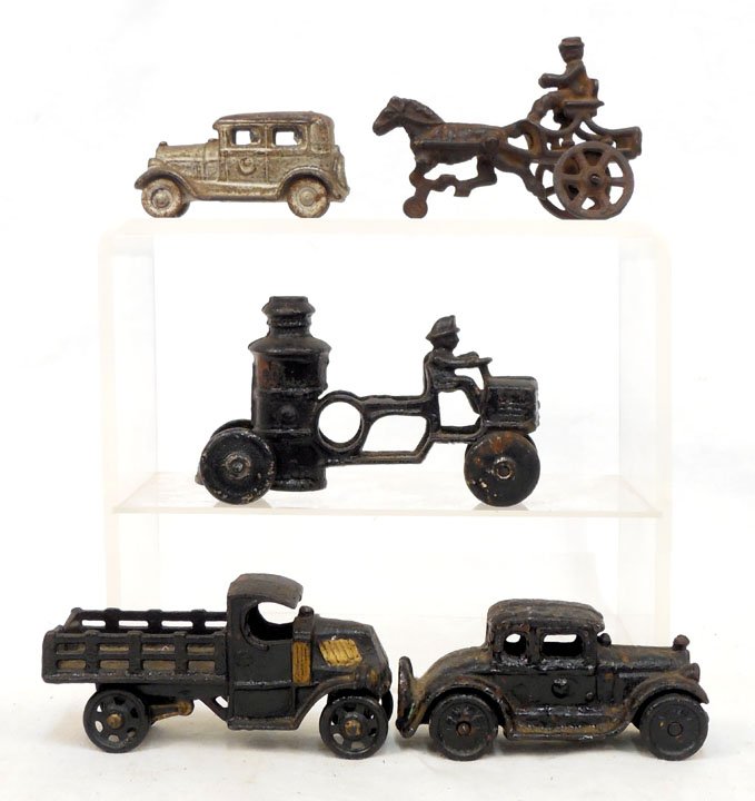 Grouping of five cast iron vehicles: Grouping of five cast iron vehicles, includes a fire pumper, 5 1/4" long, doctor horse and buggy attributed to Hubley, 4" long, stake truck attributed to Champion, 4 3/4" long, and two old timer sedan