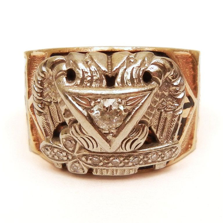 Gold and diamond Masonic ring: Gold and diamond Masonic ring, 10k yellow and white gold mounting with enameling, center mine cut diamond measuring approximately 20 points, nine 1 point diamonds in sword, 5/8" wide, marked 10k, size