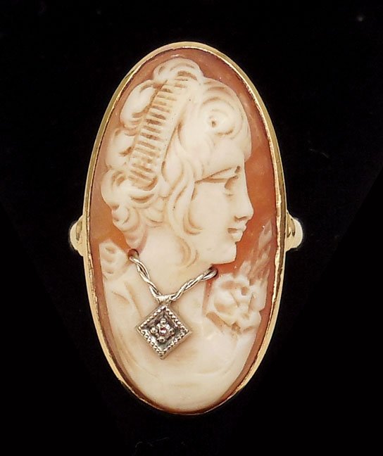 Gold cameo ring: 10k gold ring with carved shell cameo, diamond in necklace measuring approximately 0.02 carats, front of ring measures 1 3/16" long x 5/8" wide, size 6 1/2, marked 10k, weight 8.5 grams/5.5 dwt