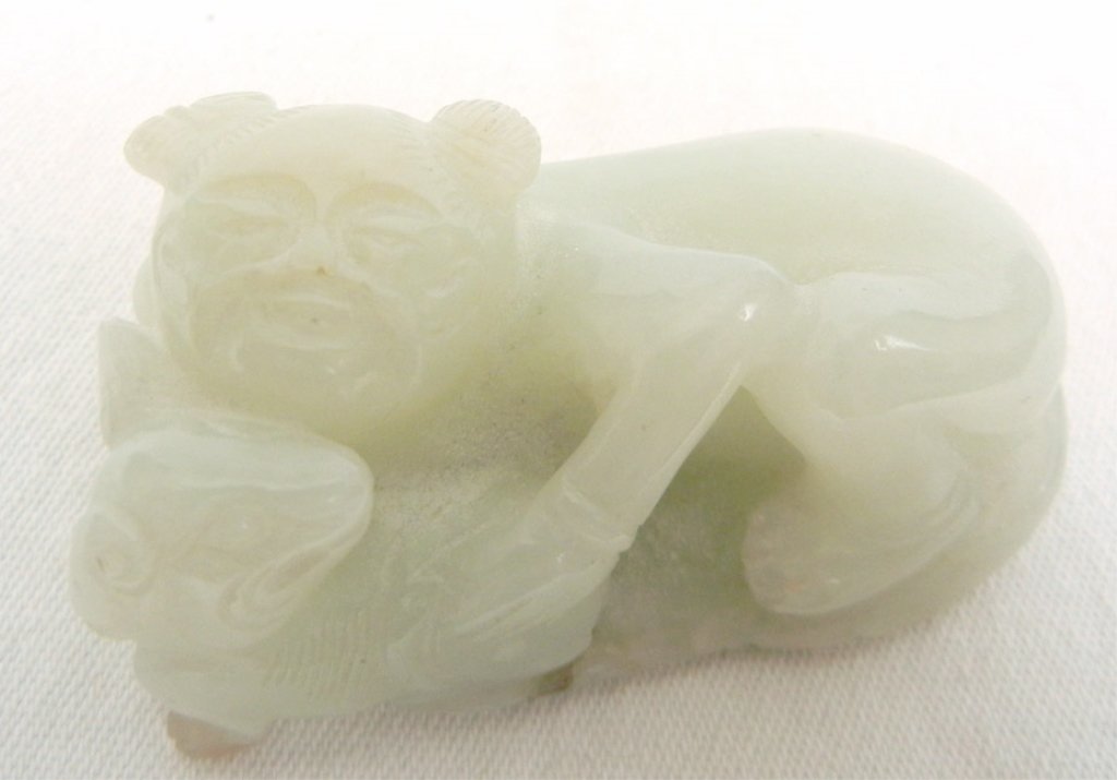 Chinese jade carving: Chinese jade carving, sleeping figure holding dog, 1" high x 2" across x 1" deep