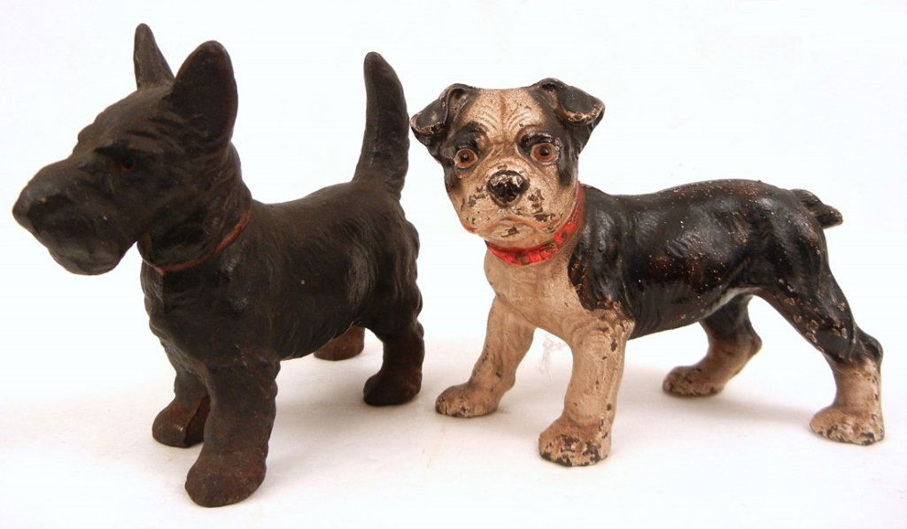 Two small cast iron dog door stops: Two small cast iron dog door stops, including a Scottie dog, 5" high x 6 1/2" across, red painted collar, and a bull dog, 4 1/2" high x 6" across, both unmarked