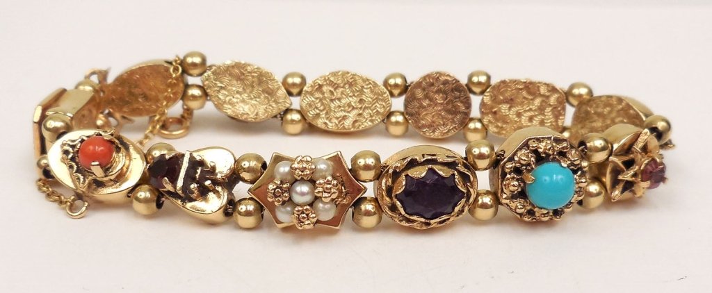 Gold slide bracelet: Victorian style 14k gold and gemstone slide bracelet, twelve slides set with colored stones including coral, garnet, amethyst, pearl, turquoise, jade and citrine, clasp with ship motif marked Bayonne 